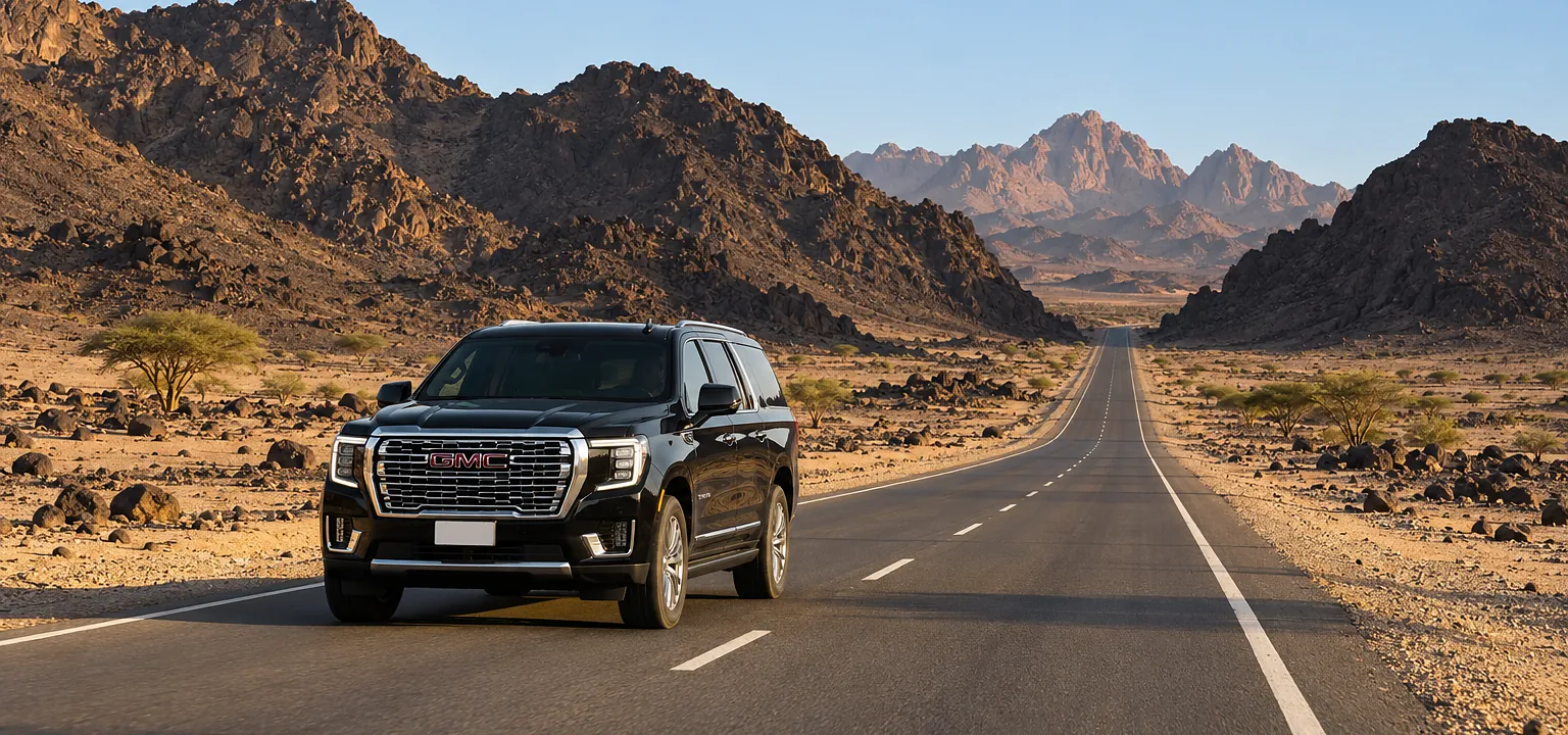 Wadi e Jinn taxi: a GMC Yukon XL on the road through Wadi al-Baida near Madinah